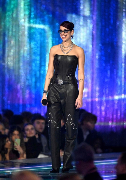 Dua Lipa attended the 2024 Brit Awards wearing a black leather double V-neck Versace gown, before she changed her outfit three more times.