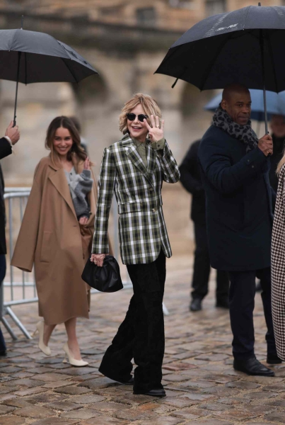 Meg Ryan was photographed walking into the Loewe womenswear Fall/Winter 2024-2025 show at Paris Fashion Week wearing a green plaid blazer and black velvet pants. The look had serious rom-com vibes.