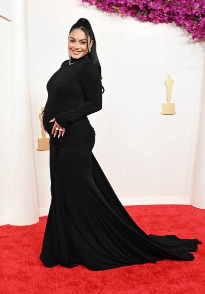 Vanessa Hudgens changed into a sheer, bump-baring gown at the 2024 Vanity Fair Oscars Party.