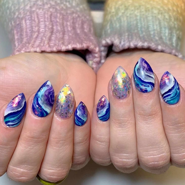 Marble nail art was popular in the early 2010s and is proving to be enduring. To show you, we rounded up over a dozen ethereal marble nail designs to dress up your mani in the months to come.