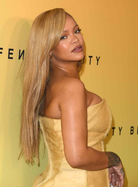 Rihanna showed off golden blonde hair and a butter yellow dress at the Fenty Launch party on Friday, April 26.