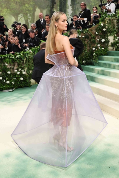 Brie Larson attended the 2024 Met Gala wearing a double-layered Prada dress. See her full sculptural look from every angle here.