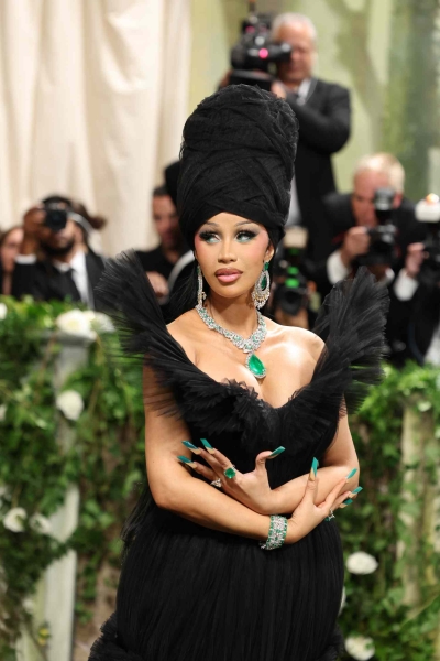 Cardi B's 2024 Met Gala dress was a gothic glam creation designed by Windowsen. The dramatic tulle gown, which featured almost 10,000 feat of fabric, covered the entire Met Gala staircase and needed its own team to carry the skirt. Designer Sensen Lii said he was inspired by the event's "Garden of Time" dress code.