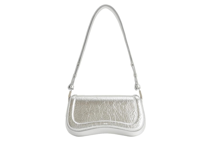 Dua Lipa carried a Jennifer Lopez-inspired silver metallic Gucci Horsebit Chain Shoulder Bag in New York City. Shop similar glitzy purses at Amazon, starting at $19.