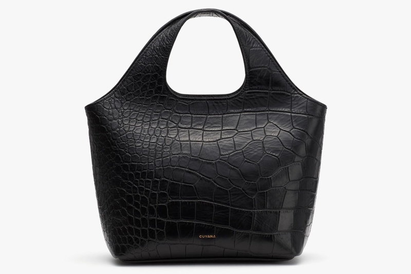 Emily Blunt just carried Cuyana’s Mini System Tote Bag in croc-embossed leather. We found her exact style, as well as Cuyana purses worn by Meghan Markle, Eva Mendes, Selena Gomez, and Zoe Saldaña.