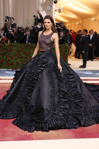 Kendall Jenner wore a plunging black gown with a sheer V-shaped panel to the 2024 Met Gala. See the full look, here.