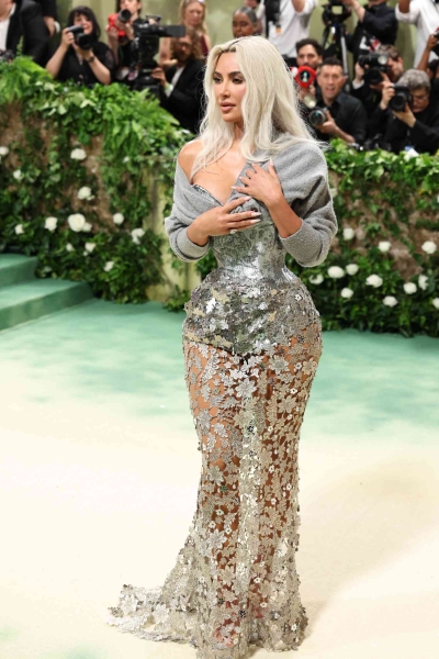 Kim Kardashian revealed that her gray sweater and her messy braid were inspired by the 2024 Met Gala theme and a memory she had of the "wildest night of [her[ life in a garden" with a boyfriend in an interview with 'Vogue.'