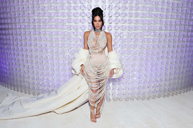 Kim Kardashian wore a gray sweater over a glam sheer metallic gown to the 2024 Met Gala. See her full look, here.