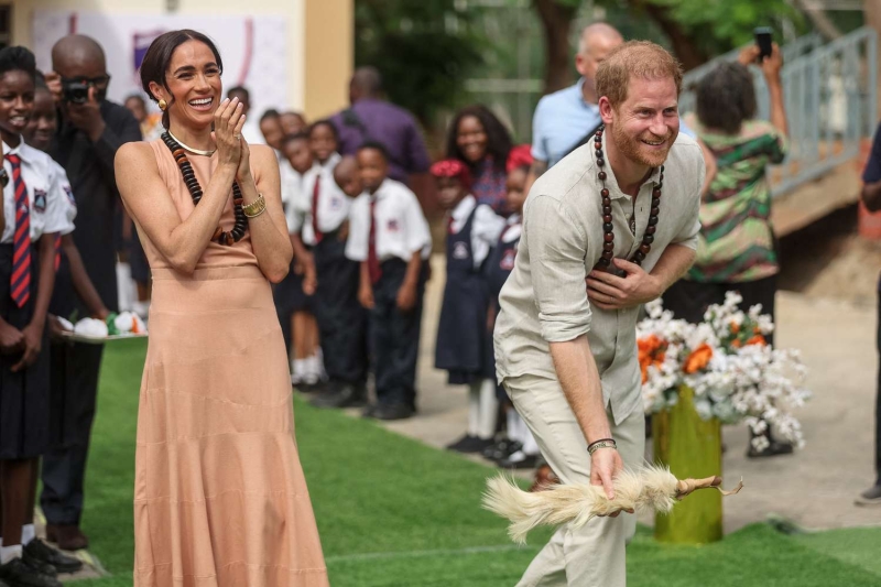 Meghan Markle and Prince Harry kicked off their Nigerian tour at the Lighway Academy, where the Duchess of Sussex wore a peach-colored maxi dress.