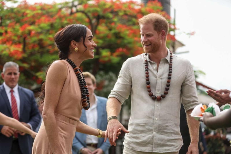 Meghan Markle and Prince Harry kicked off their Nigerian tour at the Lighway Academy, where the Duchess of Sussex wore a peach-colored maxi dress.